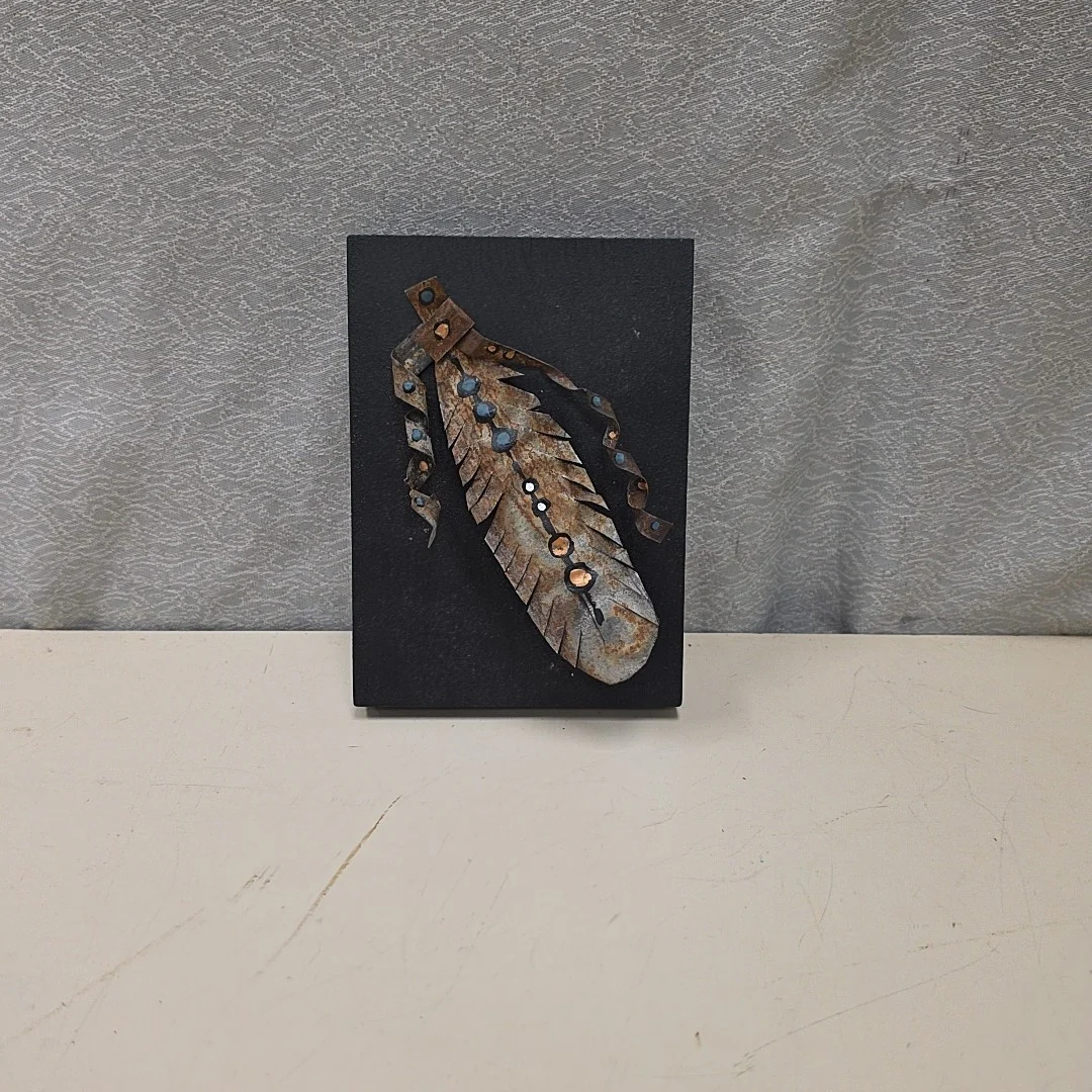 TIN FEATHER ON WOOD